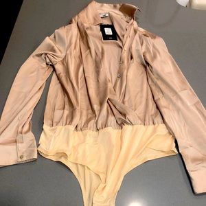 Champagne/tan color long sleeve, collared body suit.